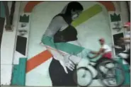  ?? LEO CORREA — THE ASSOCIATED PRESS ?? Police officers drive their bicycles past a mural art by Brazilian artist Carlos Bobi in Rio de Janeiro, Brazil, Wednesday. According to Bobi, the mural represents a special moment of his ex-wife’s pregnancy. As in many countries, abortion is a subject...