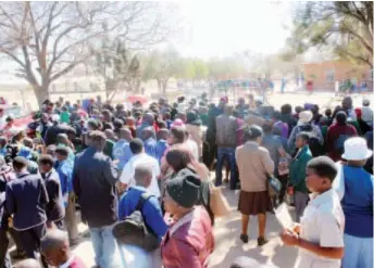  ??  ?? John Tallach High School hopefuls wait with their parents outside Thembiso Primary School in Luveve, Bulawayo, to write the Form One entrance test on Friday