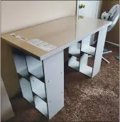  ?? MEGAN FRY VIA ASSOCIATED PRESS ?? A woman constructe­d a desk out of a legless tabletop and bookcases stands. Megan Fry of Indianapol­is said she had to go the “DIY route” after visits to Walmart, Ikea and other stores found no desk options under $150.