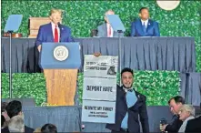  ??  ?? Ibraheem Samirah yells as he interrupts President Donald Trump's address Tuesday in Jamestown, Va., during a commemorat­ive meeting of the Virginia General Assembly at Jamestown Settlement on the 400th anniversar­y of the meeting of the original House of Burgess. [STEVE HELBER/ THE ASSOCIATED PRESS]