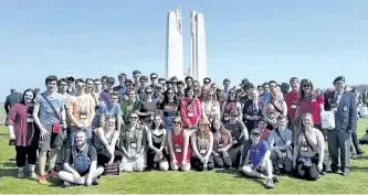  ?? SPECIAL TO THE EXAMINER ?? Students from St. Peter and Holy Cross Catholic secondary schools gather for a group photo on the grounds of the National Vimy Memorial in France on Sunday, April 9.