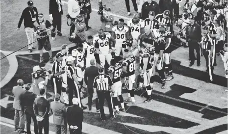  ?? USA TODAY SPORTS ?? The game captains from the Broncos, left, and Panthers line up for the coin toss Sunday in Super Bowl 50 at Levi’s Stadium.