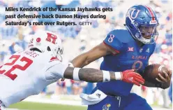  ?? GETTY ?? Miles Kendrick of the Kansas Jayhawks gets past defensive back Damon Hayes during Saturday's rout over Rutgers.