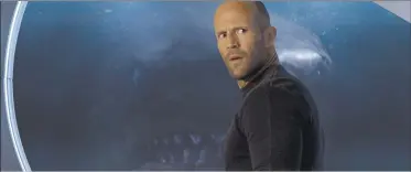  ?? Associated Press ?? This image released by Warner Bros. Entertainm­ent shows Jason Statham in a scene from the film “The Meg,” the latest in a growing school of shark movies. The hook on this one? Bigger shark.