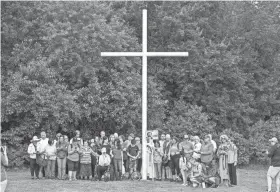  ?? ?? A group prays before a Pilgrimage from the St. John Paul II Dwelling to the Blessed Stanley Rother Shrine in Moore, on May 25.