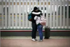  ?? MOISES CASTILLO — THE ASSOCIATED PRESS ?? Migrants embraces after receiving one of the fifty turns for an interview to request U.S. asylum, alongside the El Chaparral pedestrian border crossing in Tijuana, Mexico, Friday.