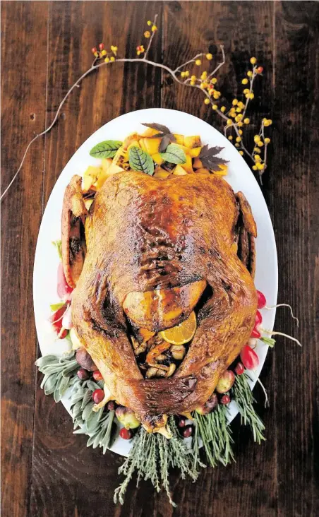  ?? Gary Coronado / Houston Chronicle ?? The Heights restaurant Southern Goods stuffs its Thanksgivi­ng turkey with satsuma oranges, rubs the skin with butter and Creole seasonings and then adds a cane-syrup and cane-vinegar-reduction gloss.