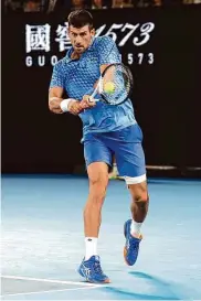  ?? Clive Brunskill/Getty Images ?? Novak Djokovic of Serbia plays a backhand in his semifinal singles win over American Tommy Paul.