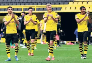  ?? REUTERS ?? Back from break: Borussia Dortmund players celebrate the rst Bundesliga goal since the lockdown began, scored by Erling Haaland.