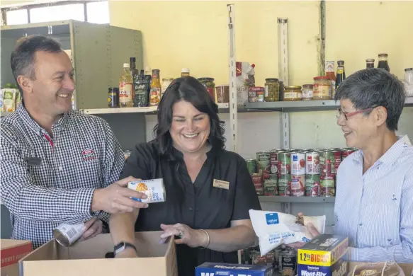  ??  ?? New World Blenheim owners Melanie and Ashley Shore and Wynnie Cosgrove from Marlboroug­h Foodbank packing deliveries.