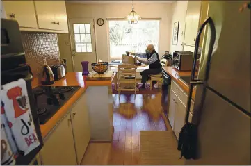  ?? PHOTOS BY JOEL ROSENBAUM — THE REPORTER ?? Fred Buderi, Interim Community Developmen­t Director for the city of Vacaville conducts a meeting via Zoom as he reviews the agenda for an upcoming planning commission meeting from the kitchen table in his Davis home.