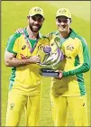  ??  ?? Australia’s Glenn Maxwell (left), and Alex Carey pose with the winners trophy after their win in the third ODI cricket match between England and Australia at Old Trafford in Manchester, England on
Sept 16. (AP)