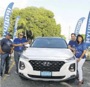  ??  ?? (From left) Carlos Geourzoung, sales manager at Magna Motors Dealership Ltd; Erick Gutierrez; Rodolfo Guzman, director of marketing at Magna Motors Dealership Ltd, and Dawn Green, assistant sales manager at Magna Motors Dealership Ltd; with the 2019 Hyundai Santa Fe, one of two sport utility vehicles the brand launched at Oxford Road facility in New Kingston recently.