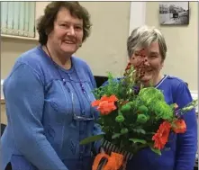  ??  ?? Kitty Bowden presents Nancy Winters with a beautiful bouquet