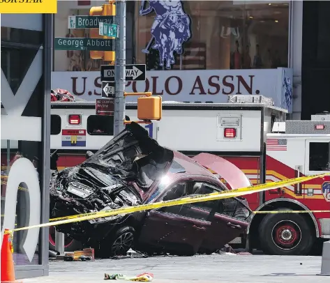  ?? SETH WENIG / THE ASSOCIATED PRESS ?? A smashed car rests against a security barrier after careening down a busy sidewalk in New York City, killing a teenager and injuring 22 others.