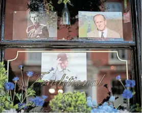  ?? Picture: HANNAH MCKAY/REUTERS ?? ROYAL DECREE: Pictures of Britain’s Prince Philip, husband of Queen Elizabeth, are seen at a window in Windsor, near London yesterday