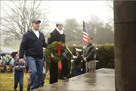  ?? LAUREN A. LITTLE — MEDIANEWS GROUP ?? Retired Third Class Petty Officer Thomas Fick, left, and Navy Sea Cadet Salvatore Machine hang the Navy wreath Dec. 14on a monument at Forest Hills Memorial Park as part of the national Wreaths Across America program.