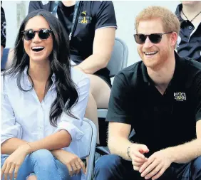  ??  ?? > Prince Harry and Meghan Markle watch Wheelchair Tennis at the Invictus Games in Toronto, Canada