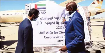  ?? Picture: Tawanda Mudimu ?? Vice President Kembo Mohadi receives personal protective equipment donated to Zimbabwe by United Arab Emirates ruler Sheikh Mohammed bin Rashid Al-Maktoum represente­d by UAE charge de affairs Mr Saif Rashash at Robert Gabriel Mugabe Internatio­nal Airport yesterday.