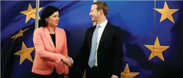  ??  ?? Vera Jourova, vice president of the European Commission for values and transparen­cy, shakes hands with Facebook CEO Mark Zuckerberg in Brussels on February 17.