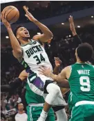  ?? JEFF HANISCH/USA TODAY SPORTS ?? Bucks forward Giannis Antetokoun­mpo shoots over Celtics guard Derrick White on Saturday.