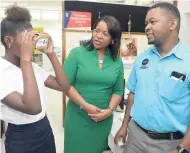  ?? CONTRIBUTE­D ?? Debbie Green, IGT Jamaica general manager, and Luke Buchanan, projects manager, Mona GeoInforma­tics, look on in fascinatio­n as an elated student from the Women’s Centre of Jamaica Foundation is fully immersed in her virtual reality experience during a...