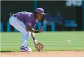  ?? ROSS D. FRANKLIN/AP ?? Colorado Rockies second baseman Adael Amador fields a ground ball hit by Arizona Diamondbac­ks’ Gabriel Moreno before throwing to first base for an out during the third inning of a spring training game Feb. 23 in Scottsdale, Arizona.