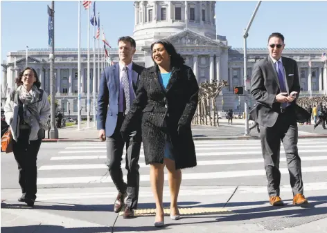  ?? Photos by Amy Osborne / Special to The Chronicle ?? Grant Colfax, the city’s new health director, and Mayor London Breed walk to the Main Library to tour the homelessne­ss health fair.