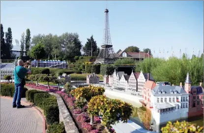  ?? ZHENG HUANSONG / XINHUA ?? A tourist enjoys his time at a mini-Europe park in Brussels on Sept 22. Restrictio­ns on visits are kept in the park as countries in the continent remain on alert for COVID-19.