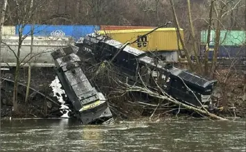  ?? Nancy Run Fire Company via AP ?? A train derailment along a riverbank Saturday in Saucon Township, Pa. Authoritie­s said it was unclear how many cars were involved, but no injuries or hazardous materials were reported.