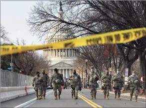  ?? Carolyn Cole / TNS ?? On the day before the presidenti­al inaugurati­on, troops guard the east side of the Capitol on Tuesday in Washington.