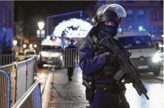  ?? Frederick Florin / AFP/Getty Images ?? A police officer patrols the streets of Strasbourg, France, after three people were killed and 11 were injured in a shooting near a Christmas market in the city.