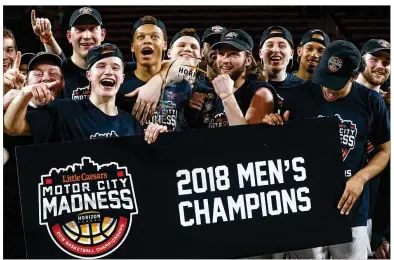  ?? PAUL SANCYA / ASSOCIATED PRESS ?? Wright State players celebrate a 74-57 win over Cleveland State in the Horizon League Tournament championsh­ip game and NCAA Tournament automatic berth Tuesday in Detroit.