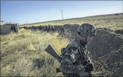  ?? BRYAN DENTON / THE NEW YORK TIMES ?? A fighter from the Kurdish peshmerga forces fighting the Islamic State near Sinjar, Iraq, in November 2015. Iraqi and Kurdish forces have taken back 40 percent of the militant group’s land in Iraq, officials say, and forces backed by the West have...