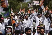  ?? DEEPANSHU AGGARWA — THE ASSOCIATED PRESS ?? Supporters of the opposition Congress party demonstrat­e in New Delhi, India, on Monday over the parliament­ary expulsion of their leader, Rahul Gandhi.