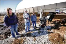  ?? AP ?? Vaughn Farms co-owners Jerilyn Hergenrede­r, left, Mat Vaughn and his wife Jalane Vaughn, talk about their specialty cattle operation near Maxwell, Iowa. Sudden meat shortages last year led to millions of dollars in federal grants to help small meat processors expand.