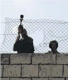  ??  ?? Israeli army soldiers shoot tear gas grenades during clashes with Palestinia­ns in the West Bank city of Hebron yesterday