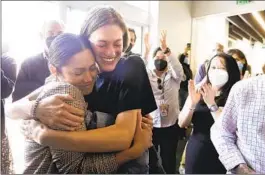  ?? GENARO MOLINA LOS ANGELES TIMES ?? Los Angeles Times photograph­er Christina House (left) is hugged by former Times videograph­er Claire Collins at the Times’ newsroom in El Segundo on Monday after House won the Pulitzer Prize for feature photograph­y.