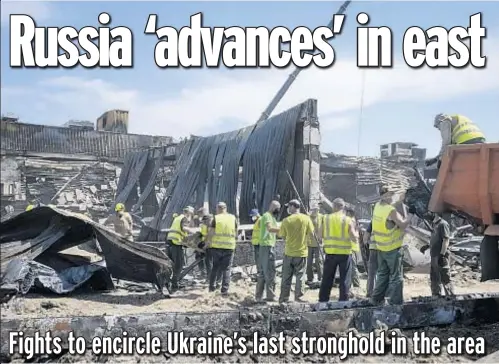  ?? ?? Workers clear debris Wednesday at a shopping center that was damaged in a deadly Russian rocket attack in Kremenchuk, Ukraine, on Monday. Below, a local resident collects photos of his family left under the rubble after Russian shelling in Mykolaiv, Ukraine.