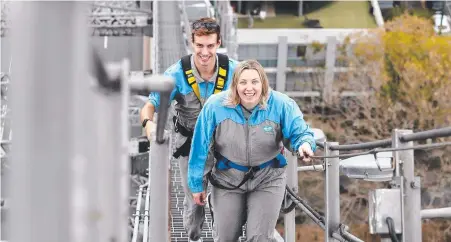  ?? Photo: Josh Woning ?? HIGH CLIMBERS: Connor McLaren-Kennedy and Courtney Worsley ascend Brisbane’s Story Bridge.