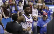  ?? ORLIN WAGNER — THE ASSOCIATED PRESS ?? Kansas forward Silvio De Sousa walks out of the crowd after a brawl against Kansas State on Tuesday.