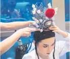  ??  ?? ABOVE A member of the Nam Hwa Opera, a Teochew opera group, gets ready for a performanc­e in Singapore.