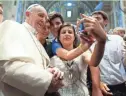  ?? L'OSSERVATOR­E ROMANO ?? Pope Francis has his picture taken inside St. Peter's Basilica with youths from the Italian Diocese of Piacenza and Bobbio in 2013.