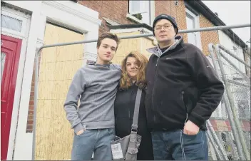  ?? Picture: Ben Fishwick ?? LUCKY ESCAPE Michael McCormick with his wife Montse and their son Mark outside their destroyed home in Whale Island Way in Stamshaw, Portsmouth