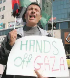  ?? — AFP ?? A Palestinia­n protests against the Israeli air strikes on Gaza on Tuesday during a demonstrat­ion in the occupied West Bank town of Hebron.