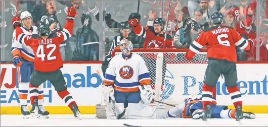  ?? Getty Images ?? AT A LOSS FOR THIRDS: The Islanders react after Curtis Lazar’s game-winning goal in the final minute of a 5-4 loss to the Devils at Prudential Center. The Isles led 4-2 entering the third period.