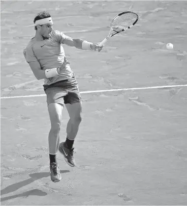  ?? AP Photo/Alessandra Tarantino ?? ■ Spain’s Rafael Nadal returns the ball to Argentina’s Juan Martin Del Potro during their French Open semifinal match Friday in Paris. The 10-time champion beat Del Potro in straight sets to secure a place in the Sunday’s final.