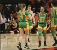  ?? AMANDA LOMAN - THE ASSOCIATED PRESS ?? Oregon’s Minyon Moore (23) celebrates with Jaz Shelley (4), Sabrina Ionescu (20) and Satou Sabally (0) following Oregon’s victory over Oregon State in an NCAA college basketball game in Corvallis, Ore., Sunday, Jan. 26, 2020.