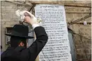  ?? (Marc Israel Sellem/The Jerusalem Post) ?? A HAREDI man preforms the kaparot ceremony in Mea She’arim yesterday