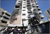  ?? OMAR SANADIKI — THE ASSOCIATED PRESS ?? People clean debris after a reported Israeli attack in which several missiles hit the western neighborho­od of the Kfar Sousseh district in Damascus, Syria, Wednesday.